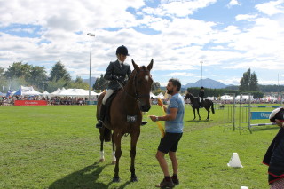 Wanaka A&P Show celebrity guest Marcus Lush presents the ribbon for Grand Champion Paced and Mannered to Melissa Hobbs, from Dunedin, on Midas Touch